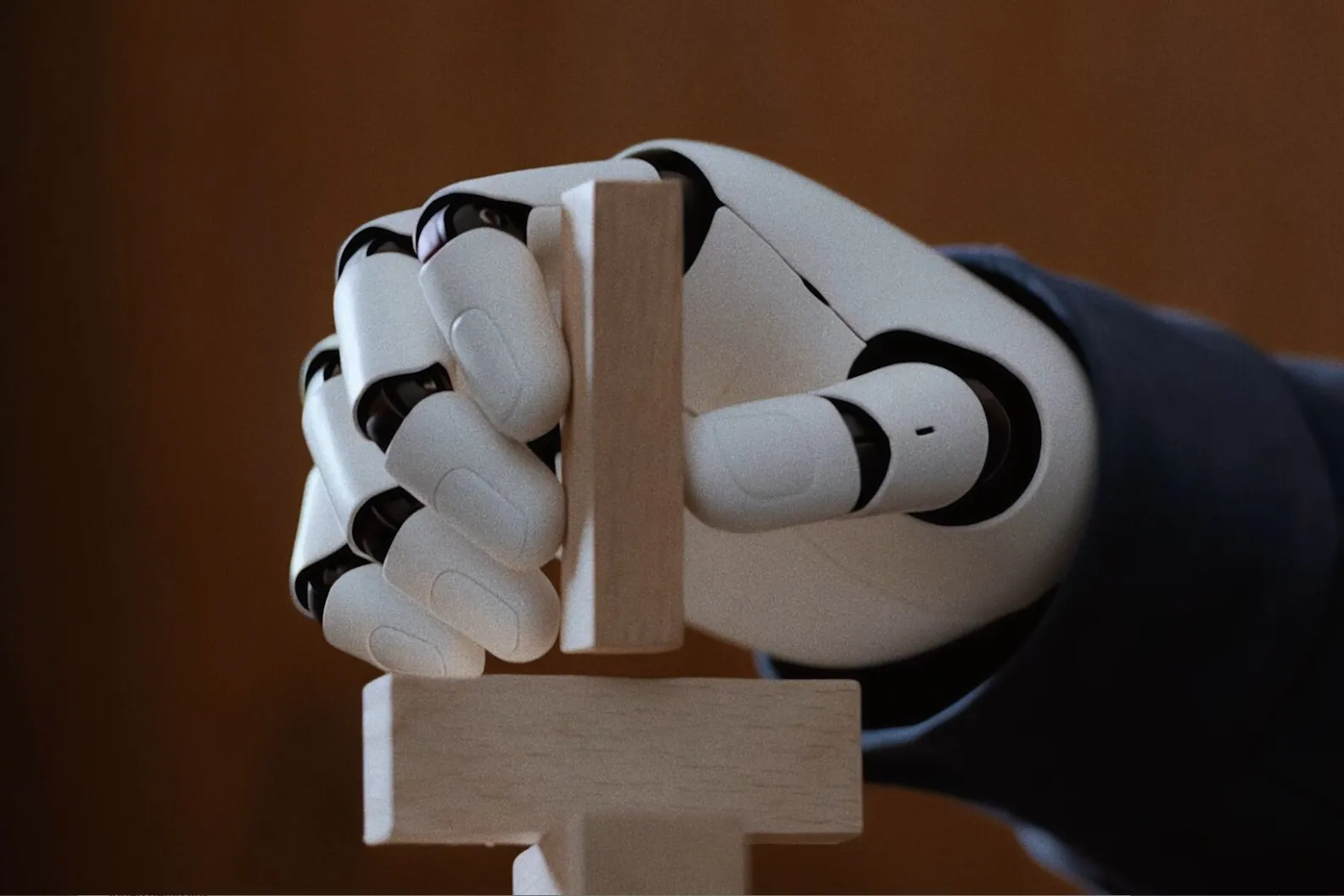 Robot hand holding a wooden block